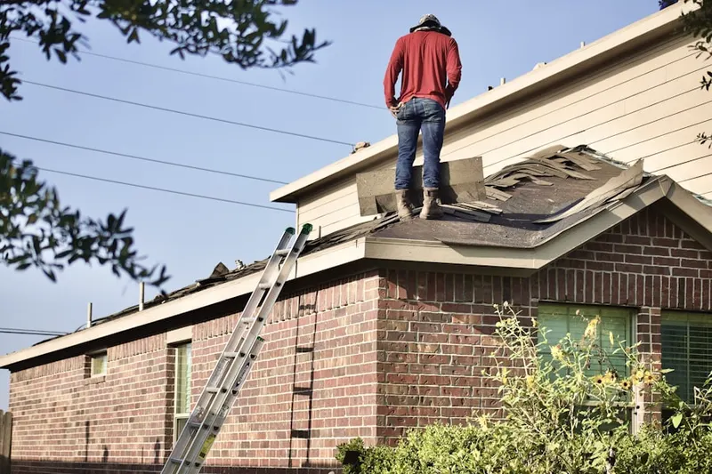 Professional roofer working on a residential roof in Suncreek